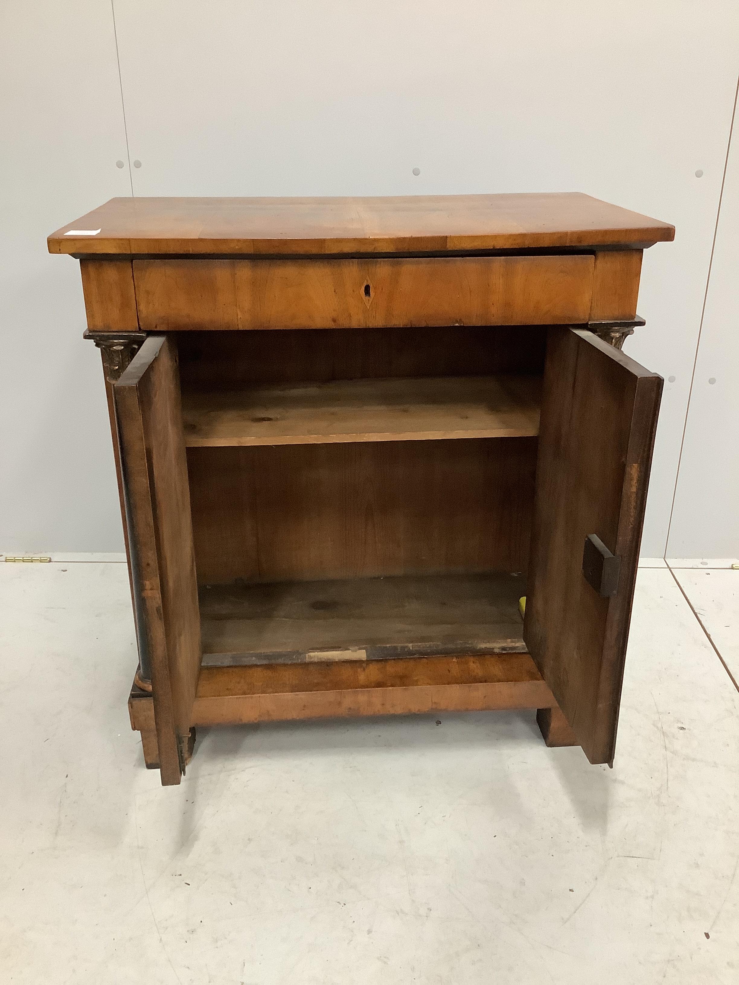 An early 19th century Biedermeier walnut side cabinet, width 82cm, depth 47cm, height 89cm